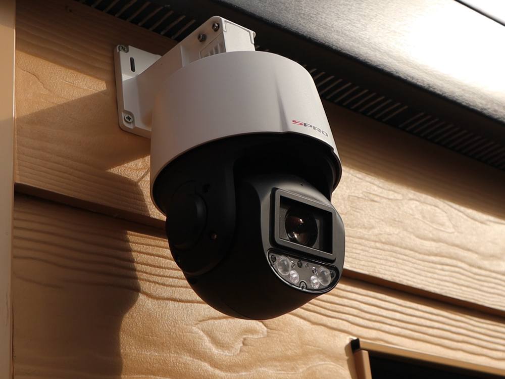A hardwired PTZ CCTV camera installed under the eaves of a house by NSS Electrics